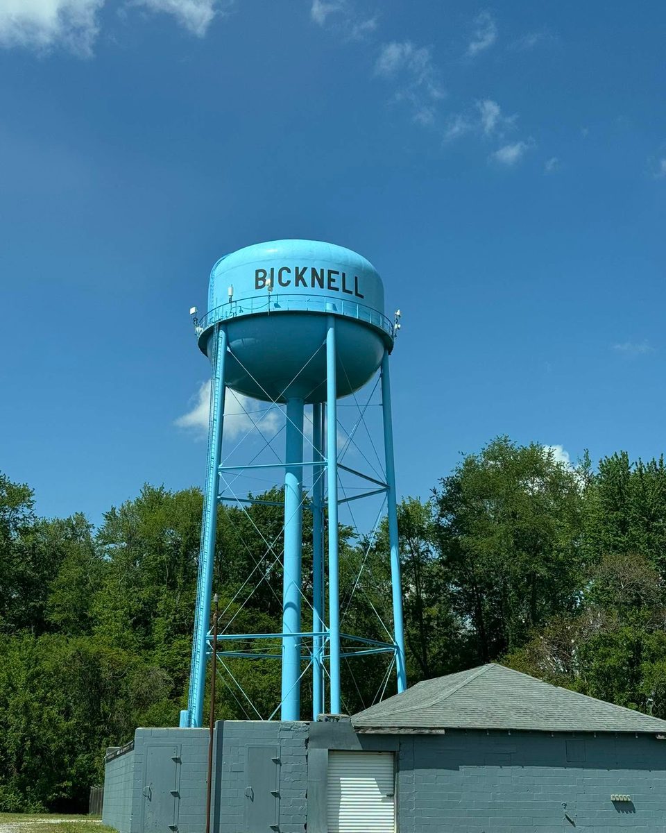 The light-blue Bicknell water tower against a summer sky